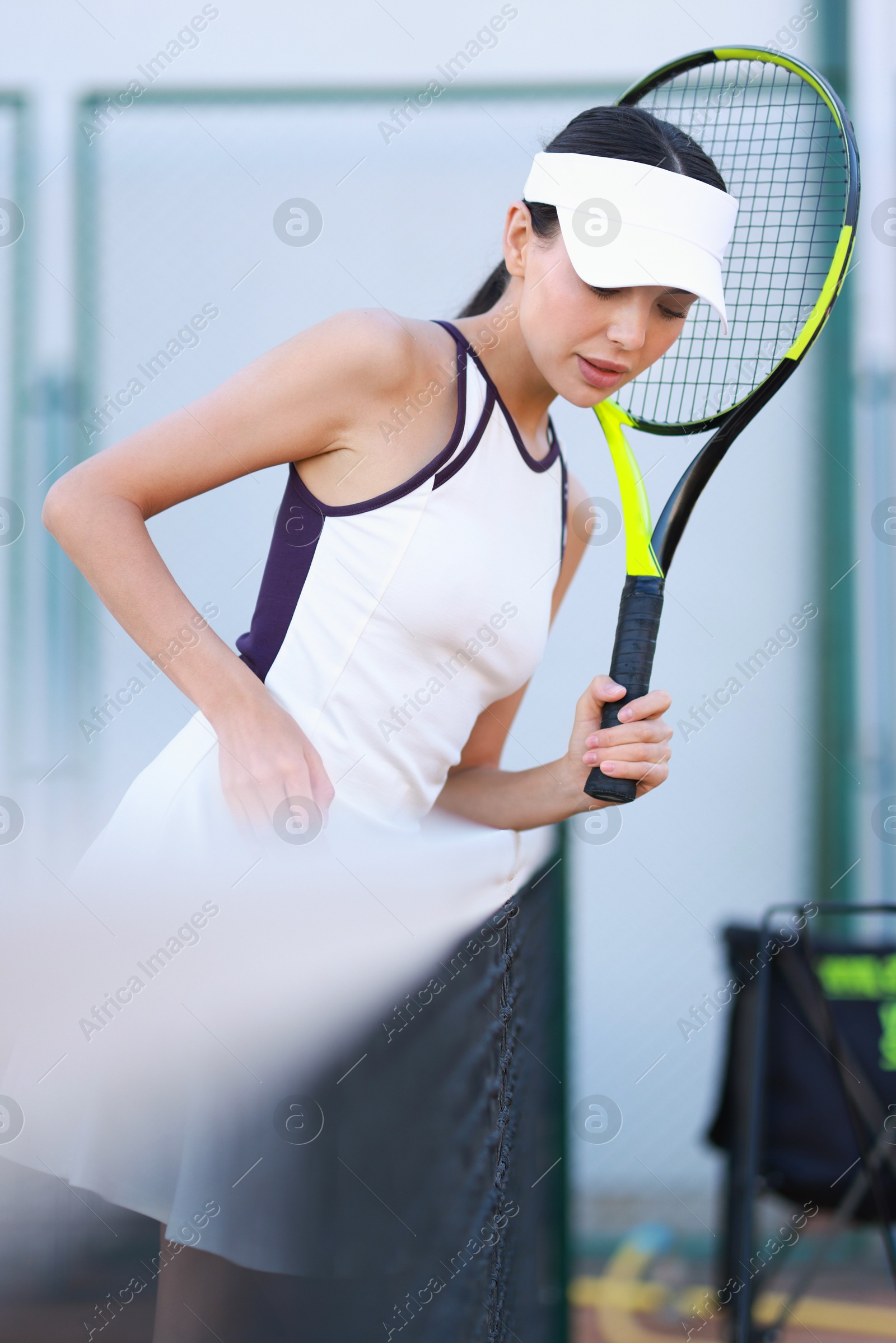 Photo of Beautiful woman with tennis racket on court