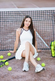 Beautiful woman in sportswear on tennis court