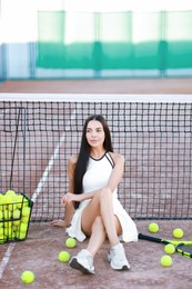 Beautiful woman in sportswear on tennis court