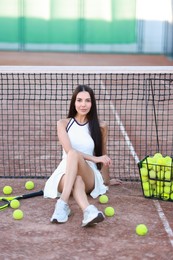 Beautiful woman in sportswear on tennis court