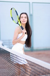 Photo of Beautiful woman with tennis racket on court