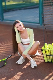 Beautiful woman in sportswear on tennis court