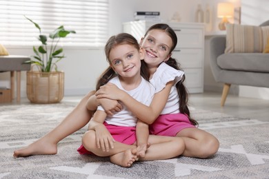 Portrait of cute little sisters at home