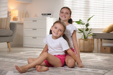 Portrait of cute little sisters at home