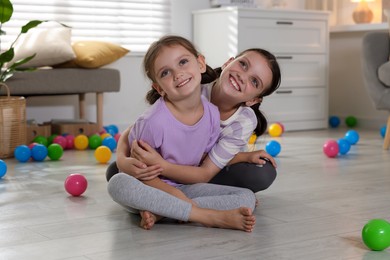 Portrait of cute little sisters at home