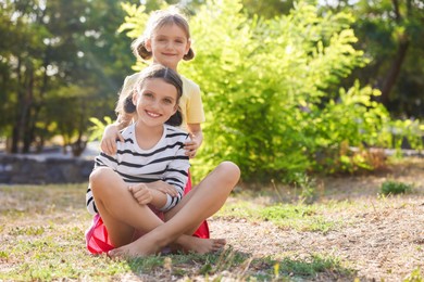 Photo of Portrait of cute little sisters in park