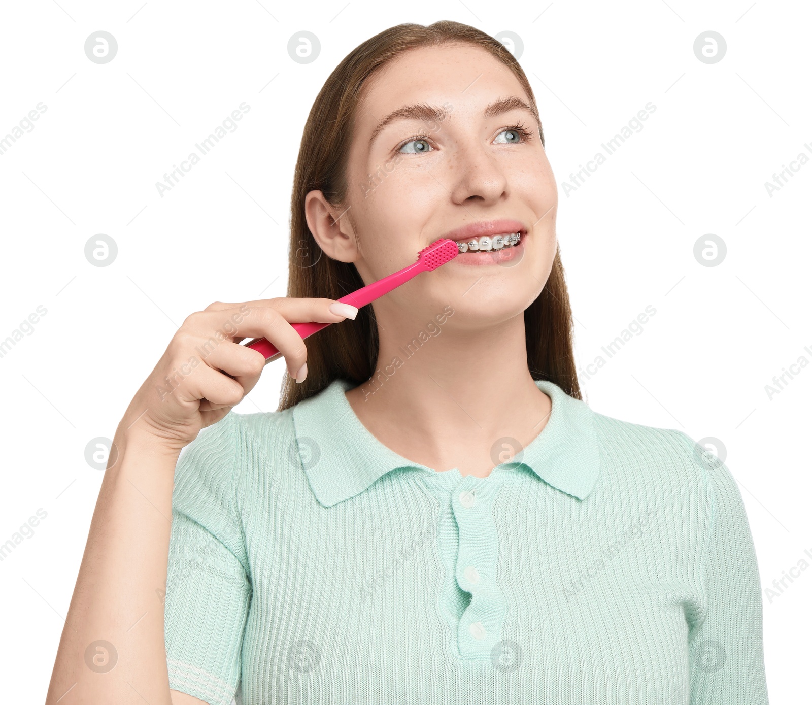 Photo of Girl with braces cleaning teeth on white background