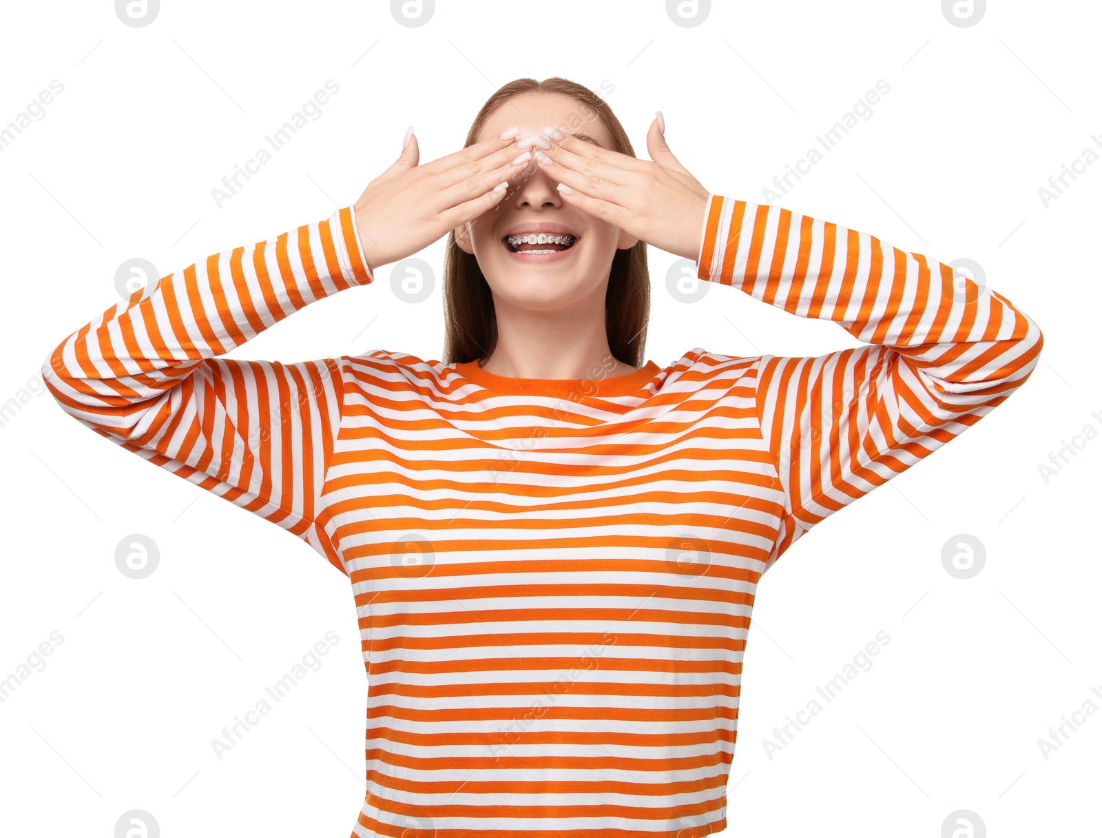 Photo of Smiling girl with braces covering eyes on white background