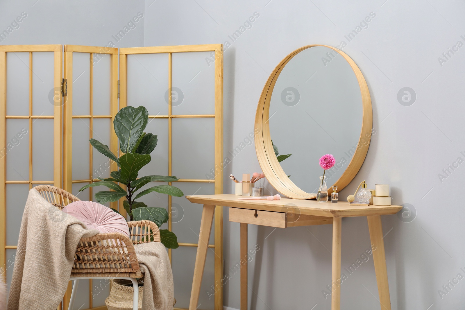 Photo of Mirror, dressing table, houseplant, folding screen and chair indoors. Interior design