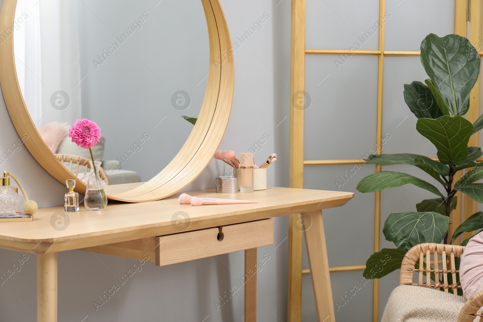 Photo of Mirror, dressing table, houseplant, folding screen and chair indoors. Interior design