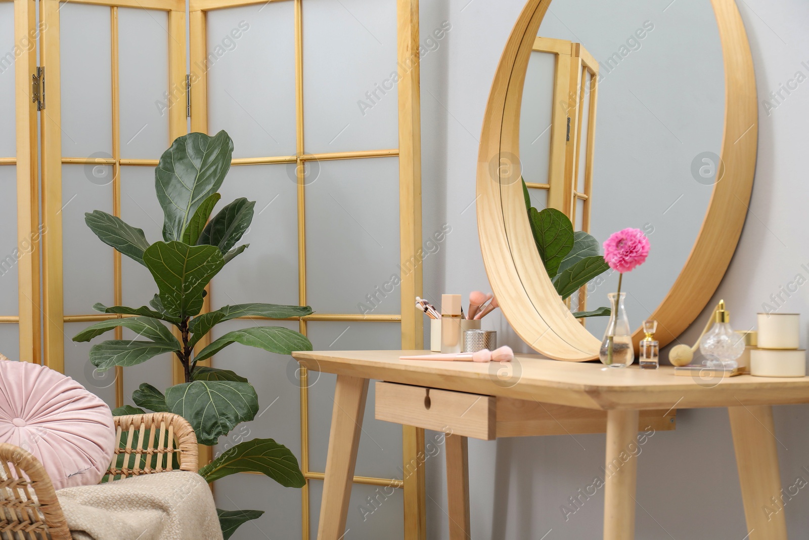 Photo of Mirror, dressing table, houseplant, folding screen and chair indoors. Interior design