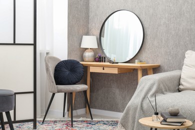 Photo of Mirror, dressing table, chairs and folding screen indoors. Interior design