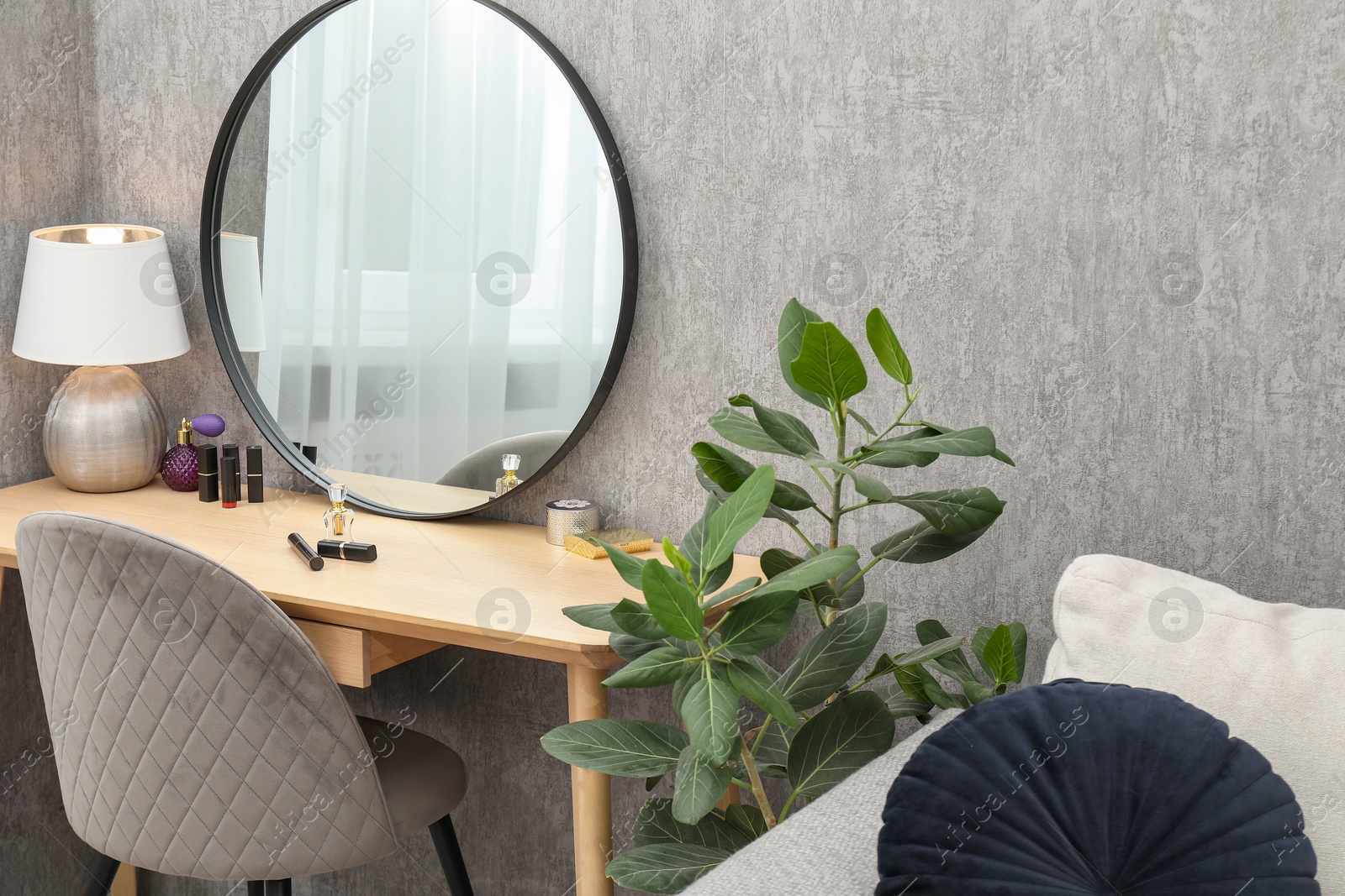 Photo of Mirror, dressing table, houseplant and chair indoors. Interior design