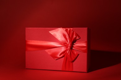 Red gift box on dark red background