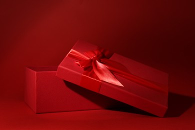 Red gift box on dark red background