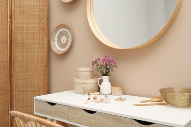 Stylish dressing table with mirror in room