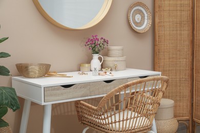 Stylish dressing table with mirror in room