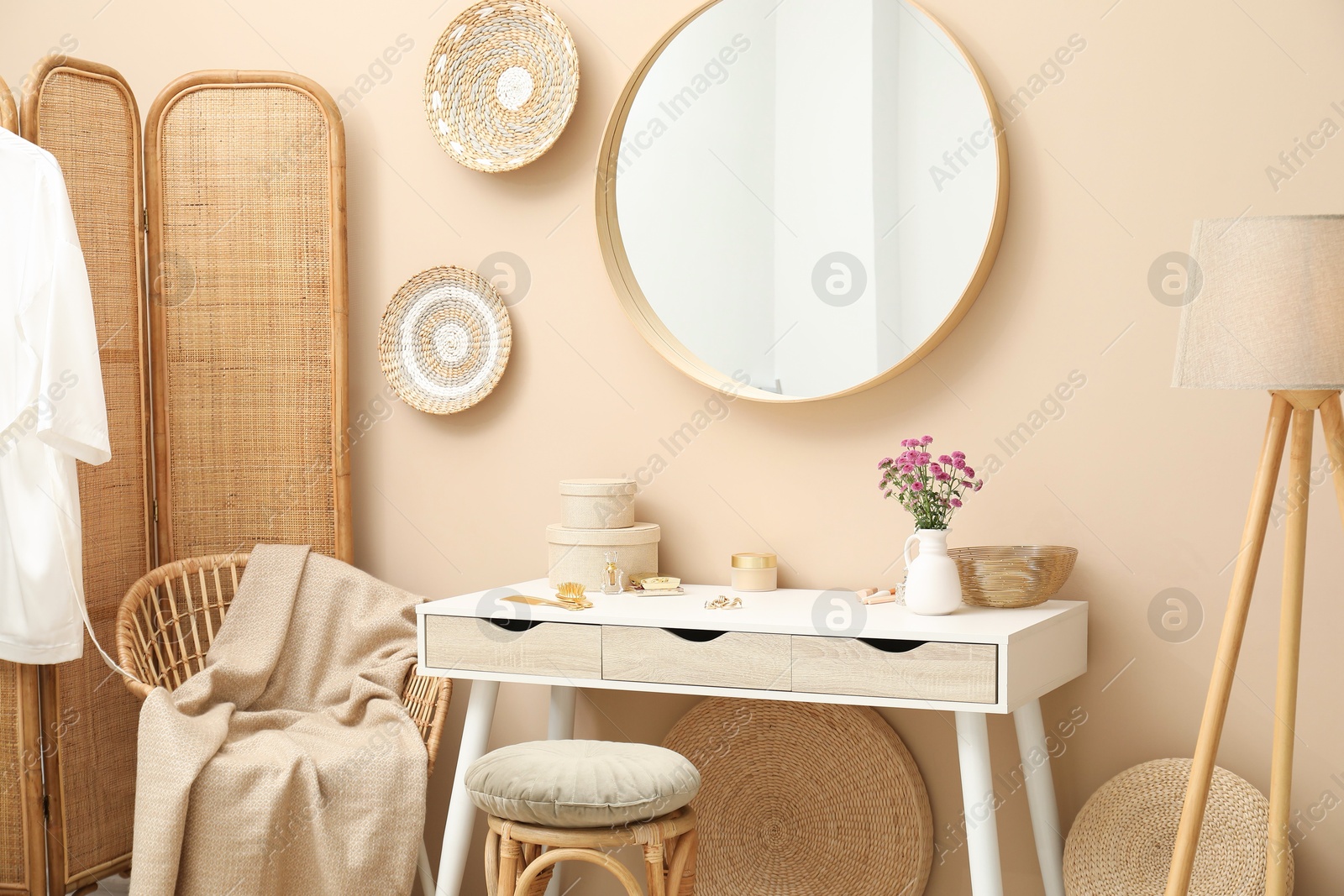 Photo of Stylish dressing table with mirror in room