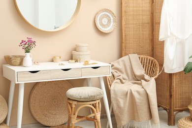 Stylish dressing table with mirror in room