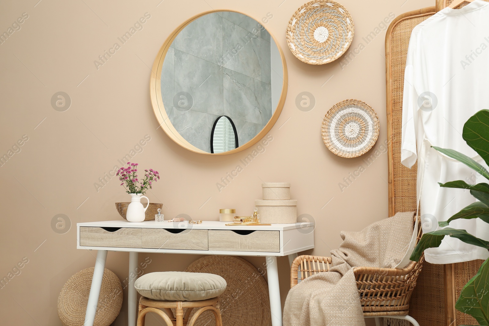 Photo of Stylish dressing table with mirror in room