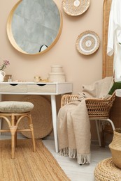 Photo of Stylish dressing table with mirror in room