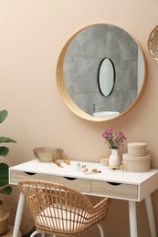 Stylish dressing table with mirror in room