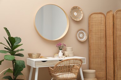 Stylish dressing table with mirror in room