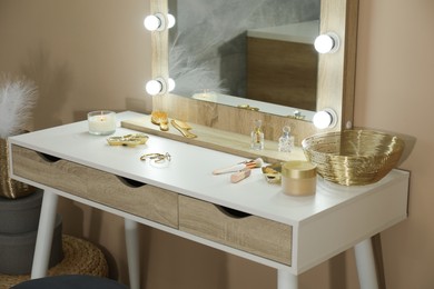 Stylish dressing table with mirror in room