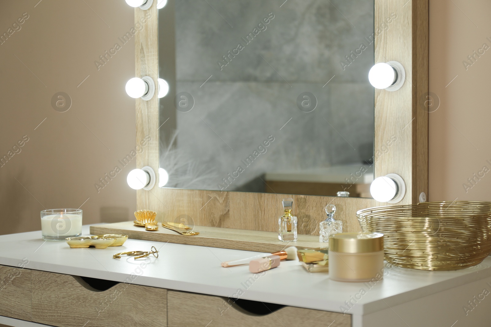 Photo of Stylish dressing table with mirror in room