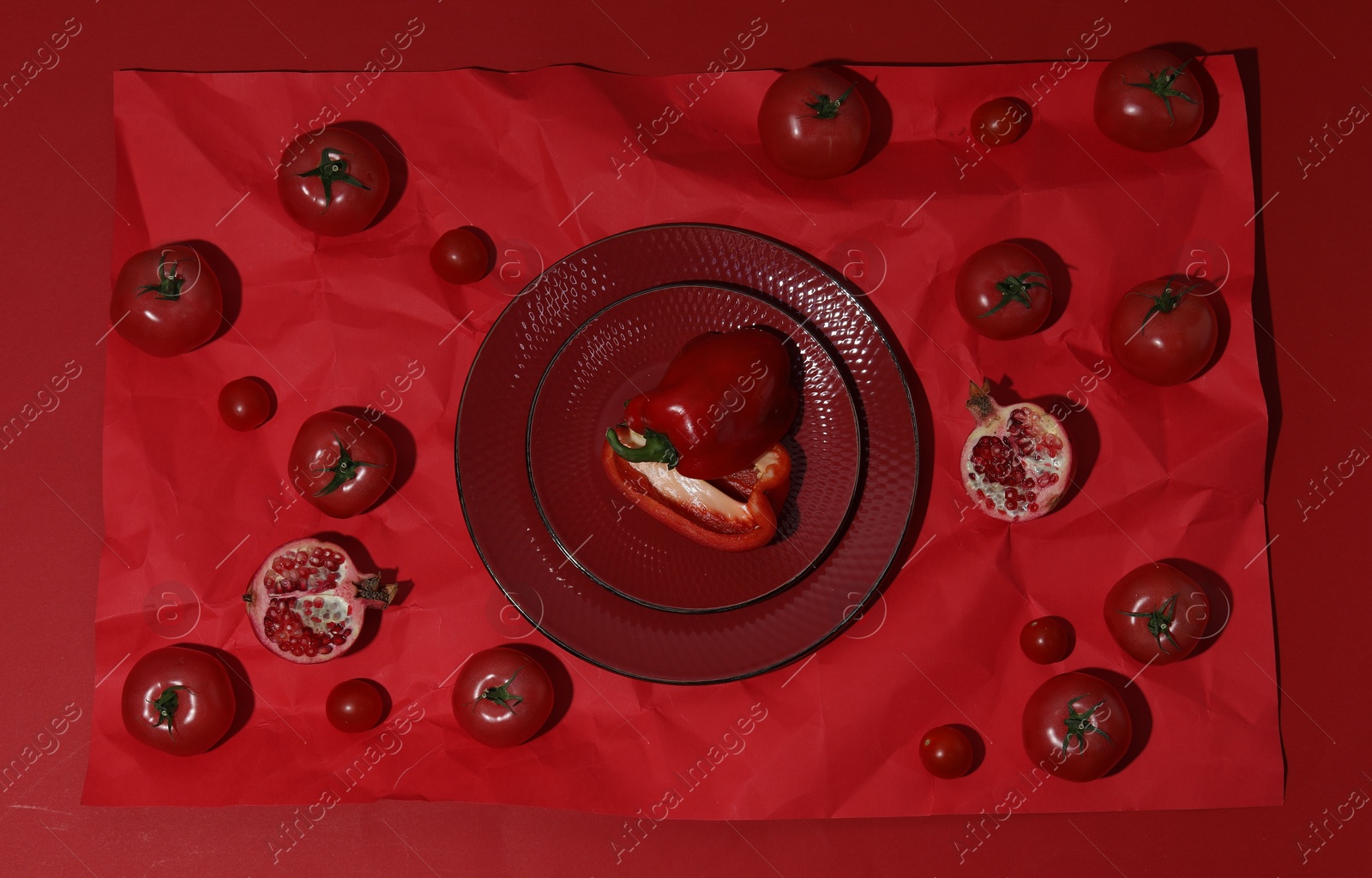 Photo of Flat lay composition with pepper, tomatoes and plates on red background