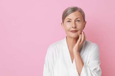 Photo of Face massage. Beautiful woman with healthy skin on pink background, space for text