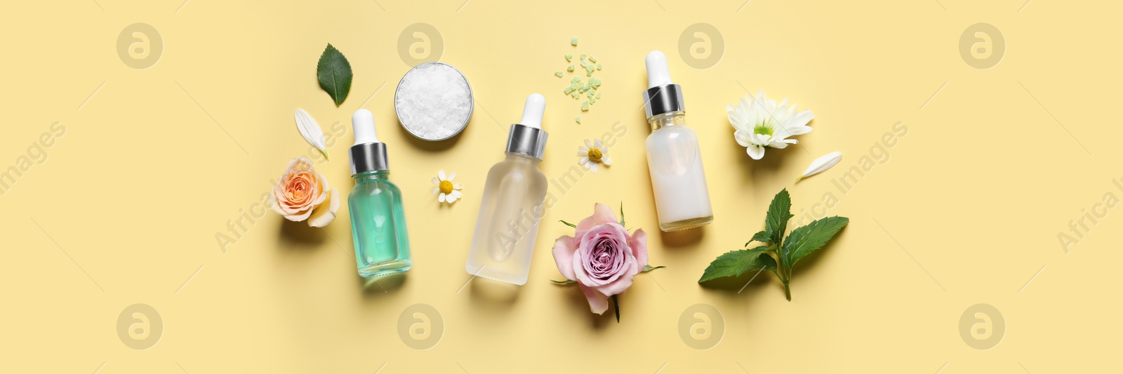 Image of Flat lay composition with cosmetic serums on pale yellow background, banner design. Spa treatment