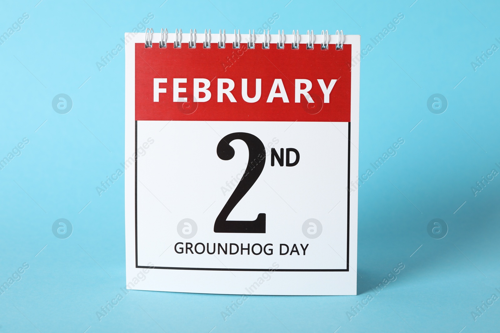 Photo of Calendar with date February 2nd on light blue background. Groundhog day