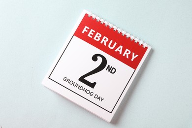 Top view of calendar with date February 2nd on light background. Groundhog day