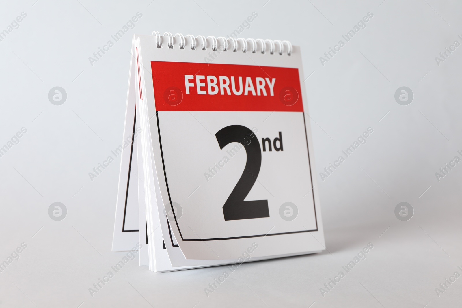 Photo of Calendar with date February 2nd on light background. Groundhog day