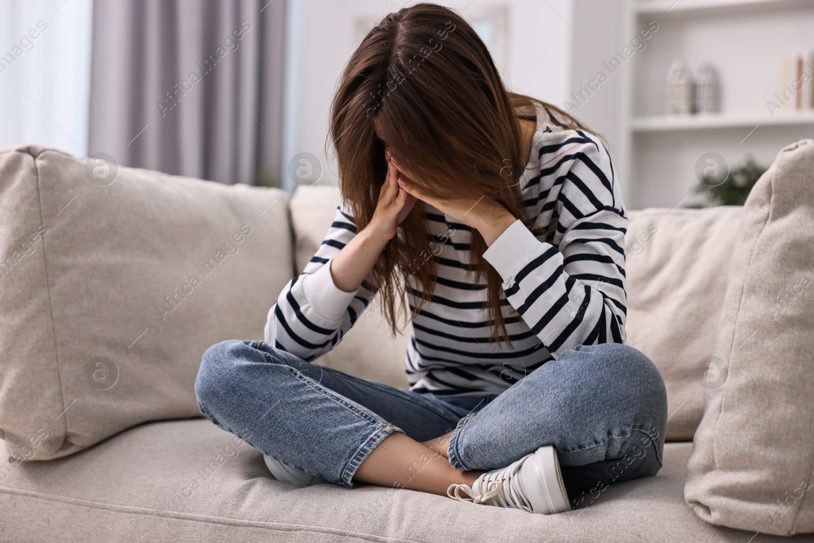 Photo of Loneliness concept. Sad teenage girl on sofa at home