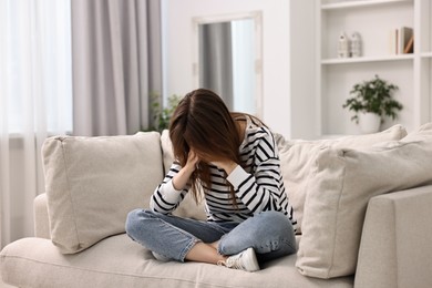 Photo of Loneliness concept. Sad teenage girl on sofa at home