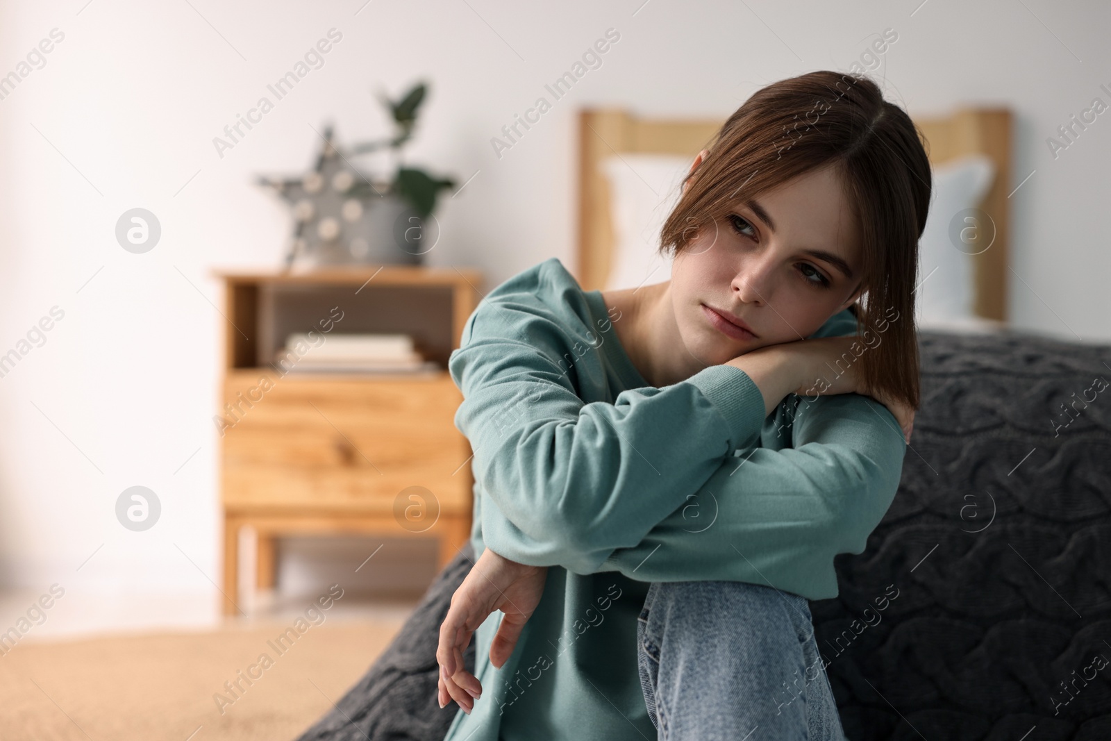 Photo of Loneliness concept. Sad teenage girl at home