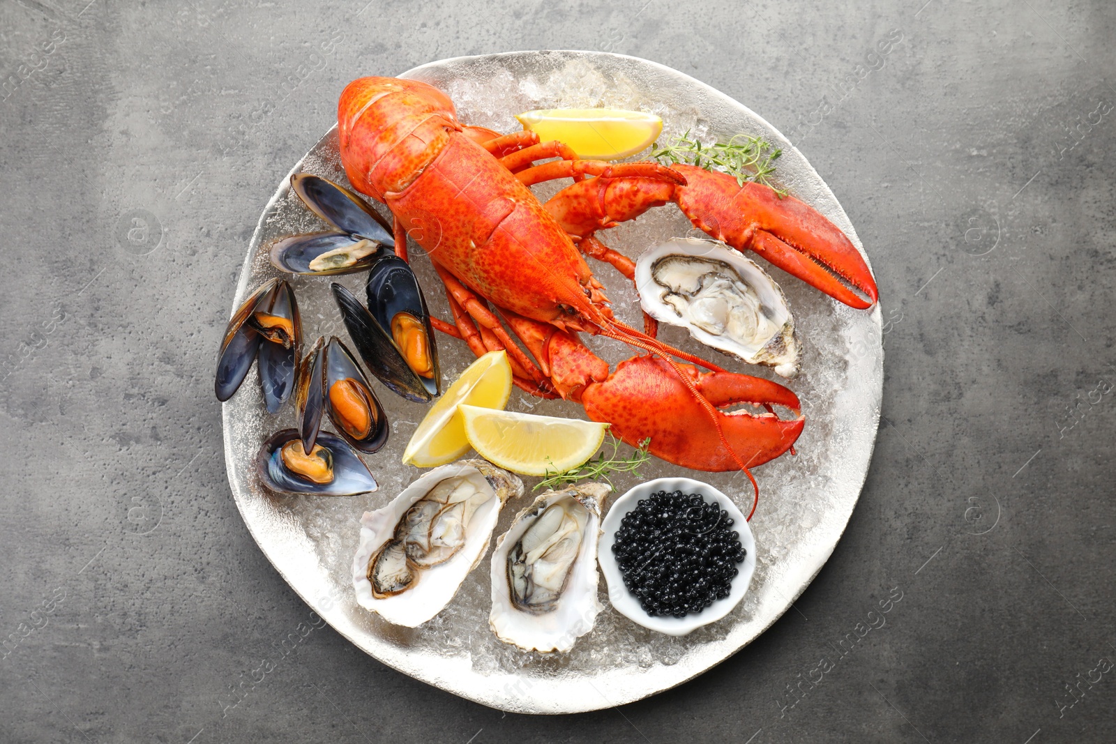 Photo of Different sea food on grey table, top view