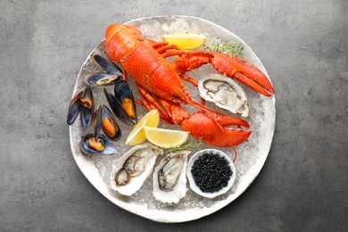 Different sea food on grey table, top view