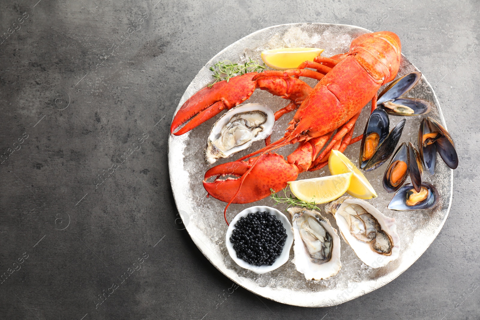 Photo of Different sea food on grey table, top view. Space for text