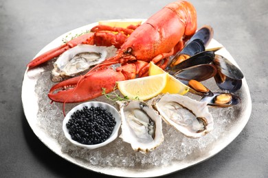 Photo of Different sea food on grey table, closeup