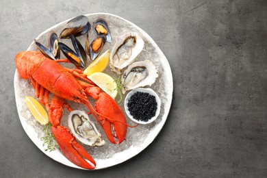 Photo of Different sea food on grey table, top view. Space for text