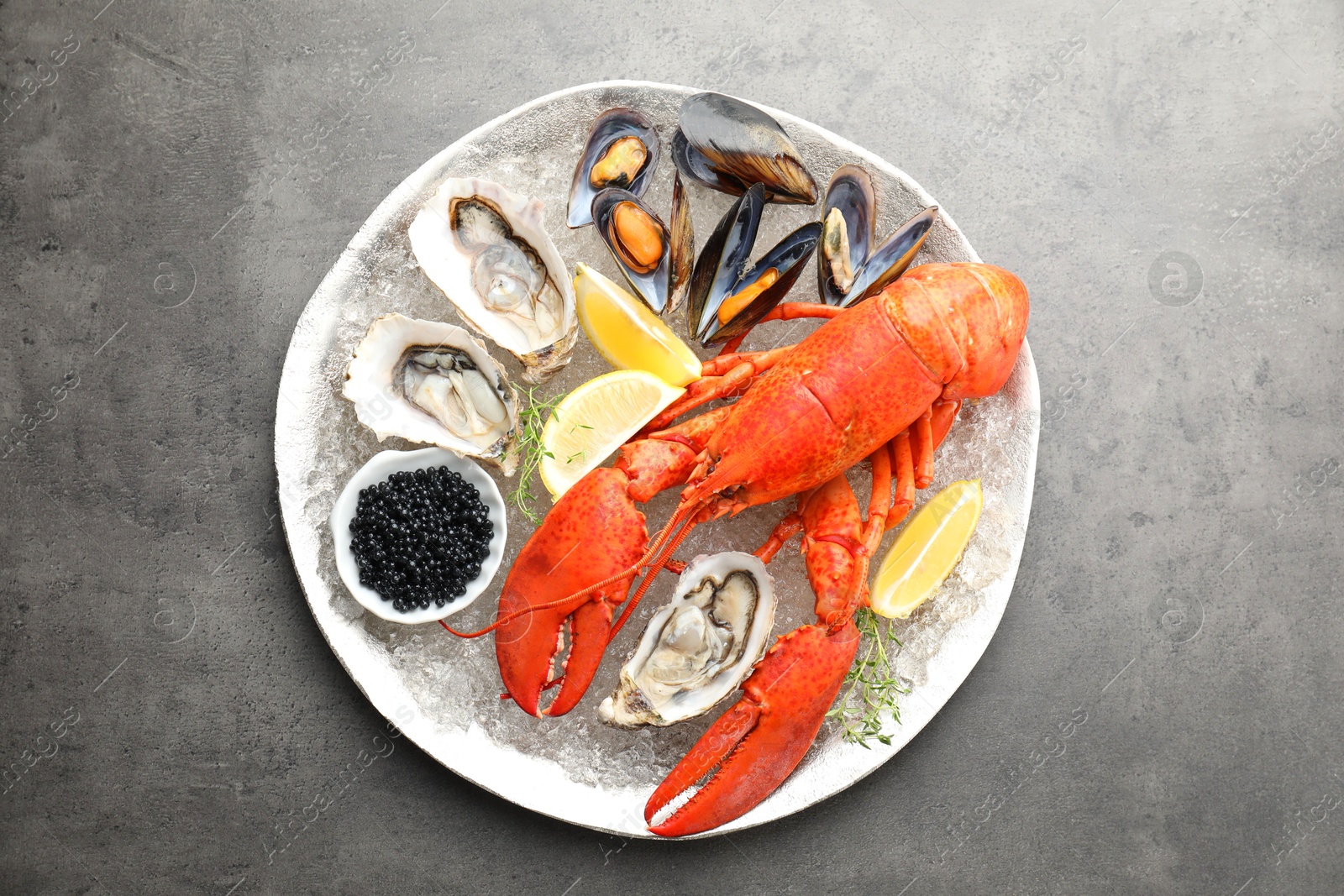 Photo of Different sea food on grey table, top view