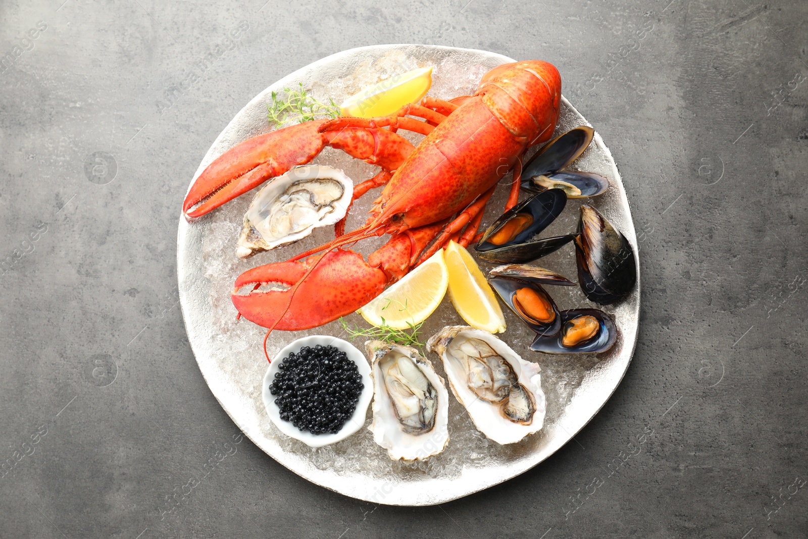 Photo of Different sea food on grey table, top view