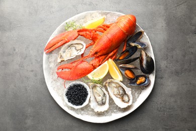 Different sea food on grey table, top view