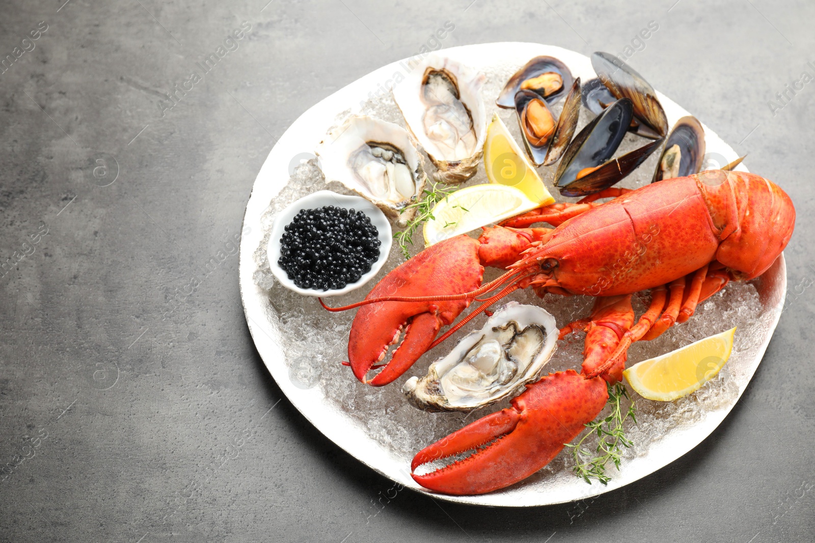 Photo of Many different sea food on grey table