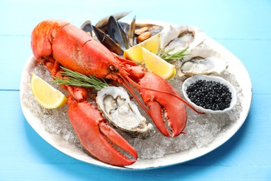 Photo of Many different sea food on light blue wooden table, closeup