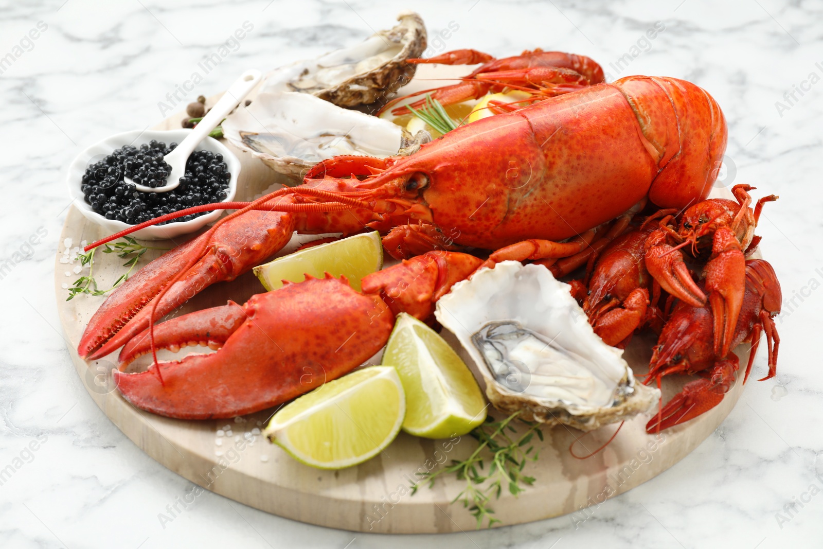 Photo of Many different sea food on white marble table, closeup