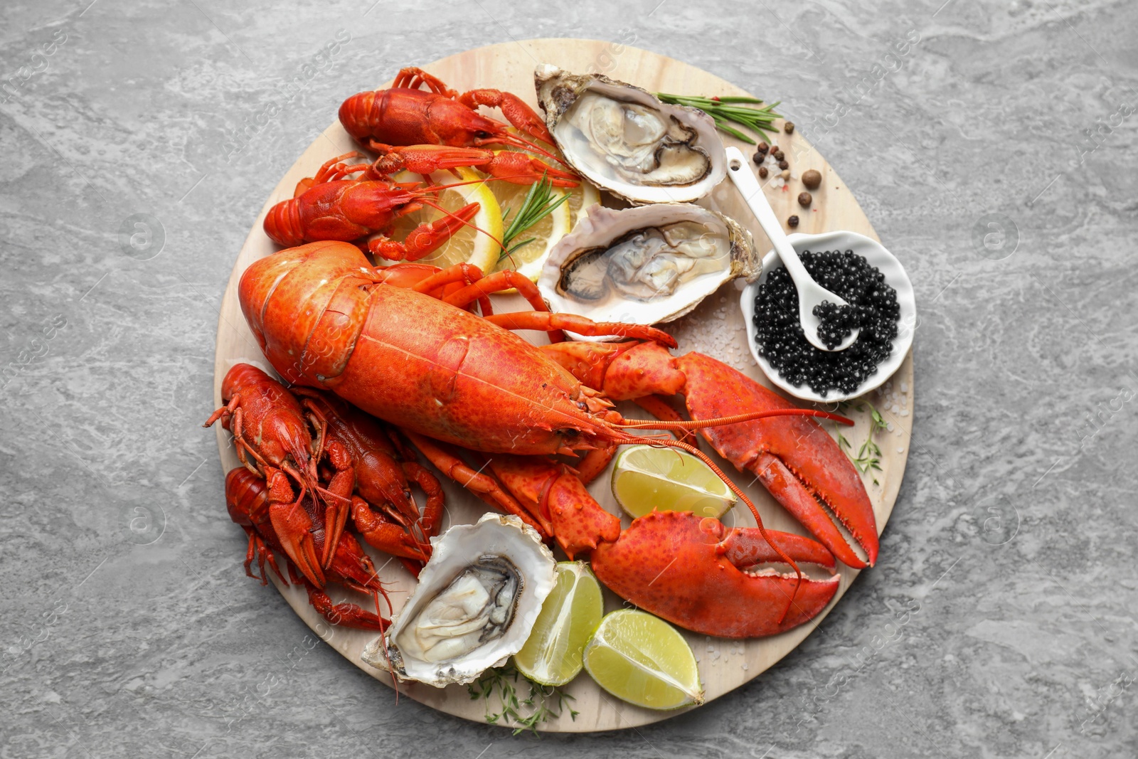 Photo of Many different sea food on grey table, top view